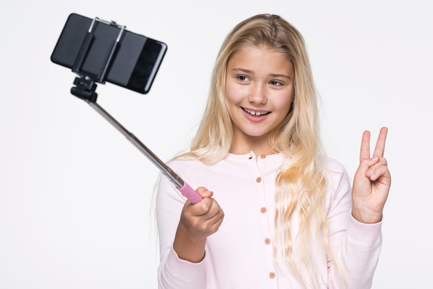 Free Photo smiley girl taking selfies of herself