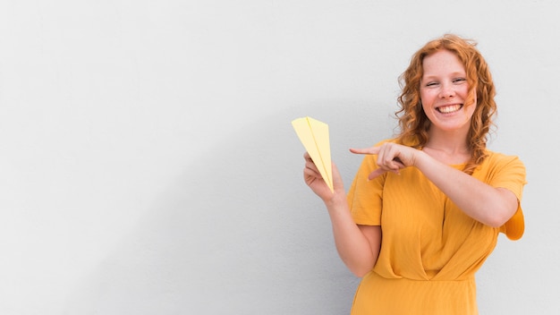 Smiley girl with plane and copy-space