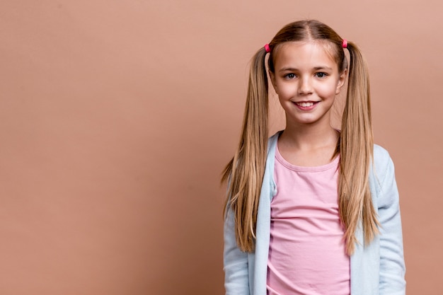 Smiley girl with poly tails and copy space