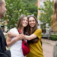 Free photo smiley girlfriends hugging