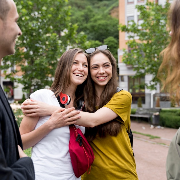 Free Photo smiley girlfriends hugging