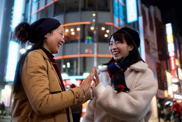 Smiley girls in city medium shot