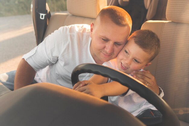 Smiley kid holding the steering wheel