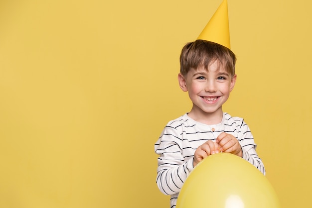 Free Photo smiley little boy isolated on yellow