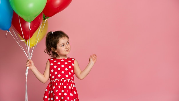 Free Photo smiley little girl in a red dress