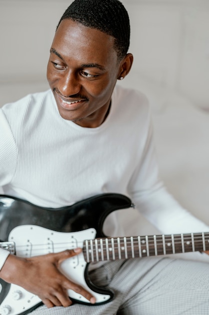 Smiley male musician with electric guitar