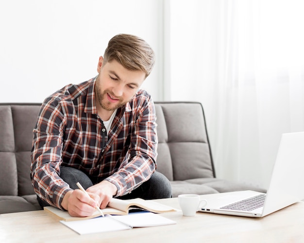 Smiley male writing