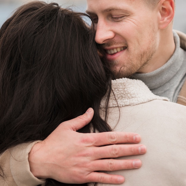 Free Photo smiley man embracing woman