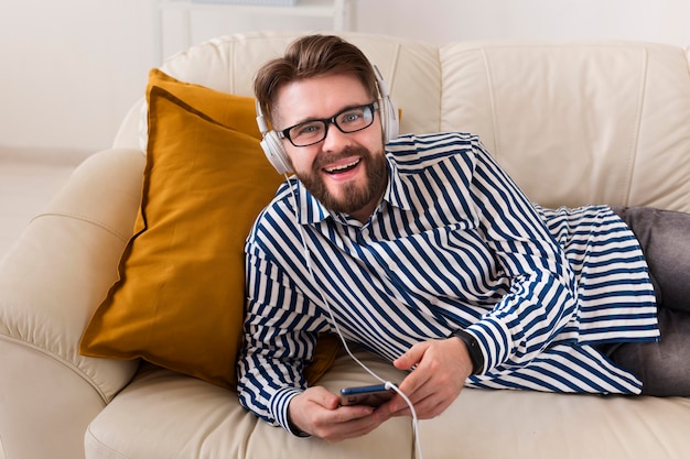 Smiley man enjoying music on headphones