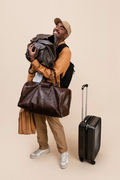 Smiley man holding bags full shot