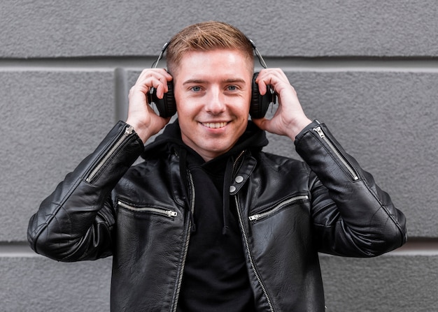 Free Photo smiley man listening to music on headphones