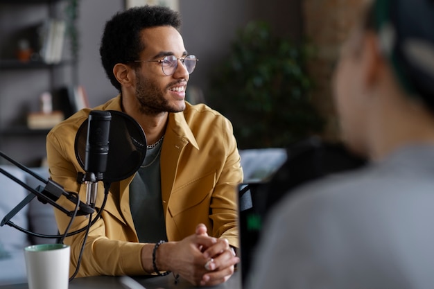 Smiley man talking at podcast