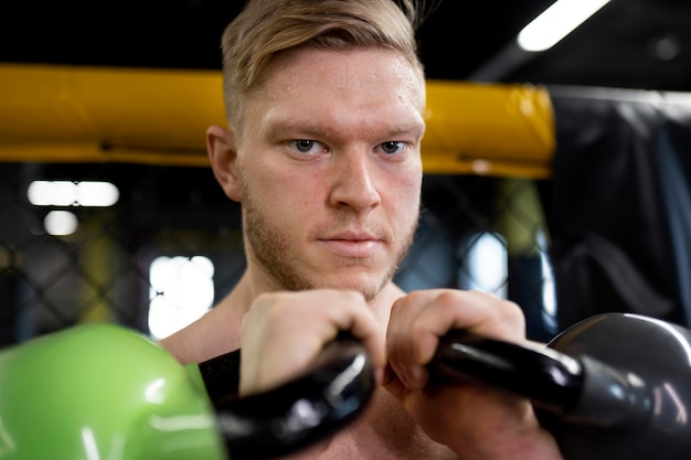 Smiley man training with kettlebells