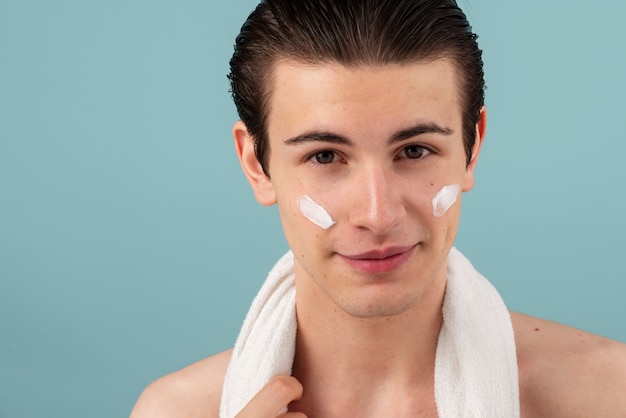 Smiley man with face cream  front view