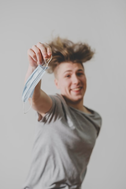 Free Photo smiley man with medical mask jumping in the air