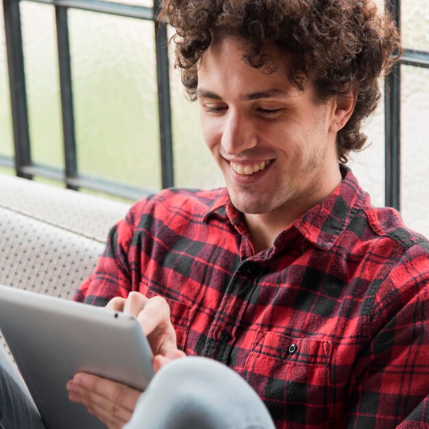 Smiley man working on tablet