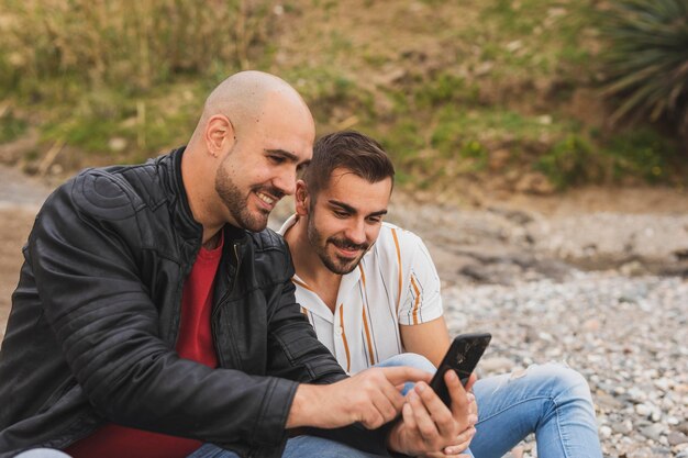 Smiley men checking mobile