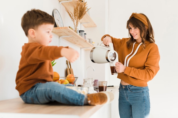 Free Photo smiley mom preparing coffee