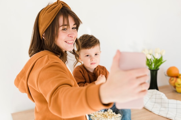 Free photo smiley mom taking selfie