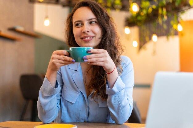 Smiley nomad woman with coffee