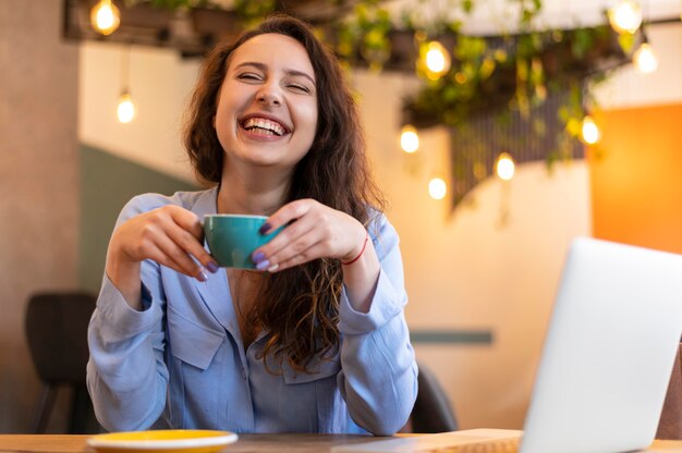 Smiley nomad woman with cup