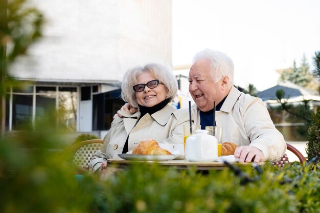 Smiley old people dating outdoors medium shot