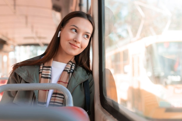 Smiley passenger looking outside the window of a tram