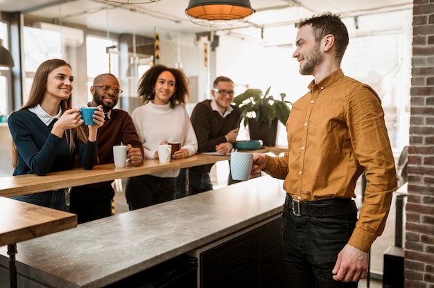 Free Photo smiley people having coffee during a meeting