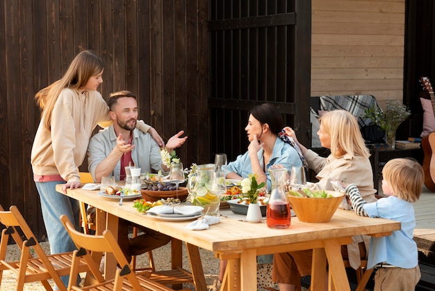 Smiley people sitting at table medium shot