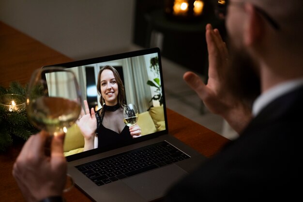 Smiley people at virtual date on laptop high angle