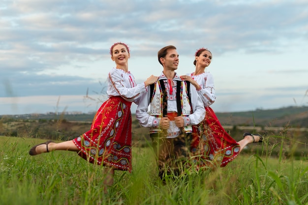 Free Photo smiley people wearing traditional clothes full shot