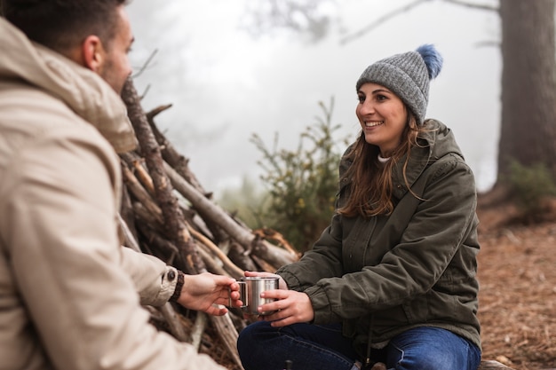 Free photo smiley people with drink outdoors