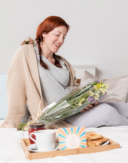 Smiley pregnant woman surprised at home