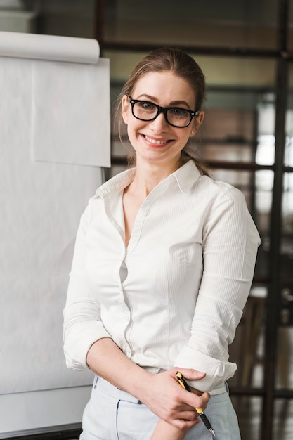 Free Photo smiley professional businesswoman with glasses doing a presentation