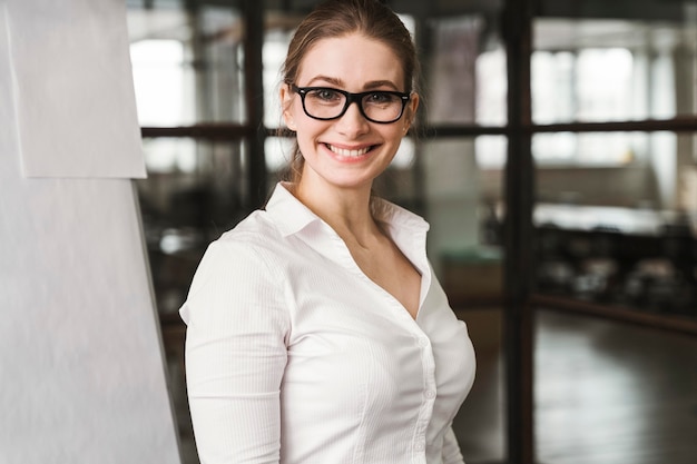 Smiley professional businesswoman with glasses during a presentation