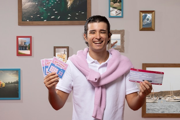 Free photo smiley rich man holding lottery tickets front view