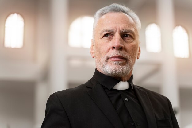 Smiley senior priest at church with costume