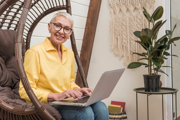 Smiley senior woman working on her laptop