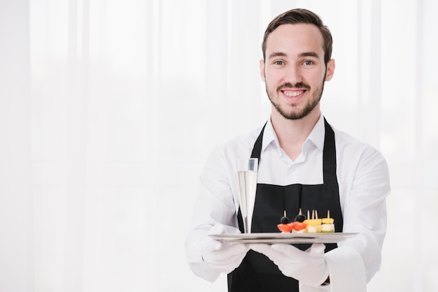 Smiley sommelier showing tray with copy space