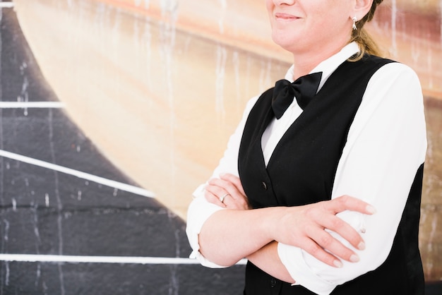 Free Photo smiley waiter holding hands and waiting to serve