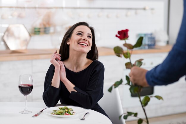 Smiley woman being surprised by her husband