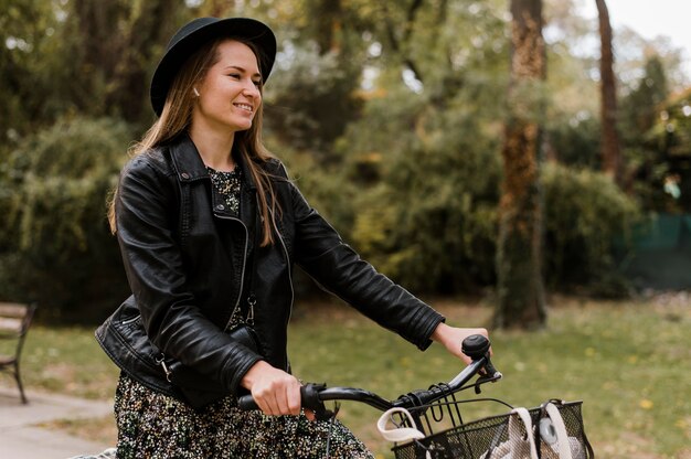 Smiley woman and bike in the park