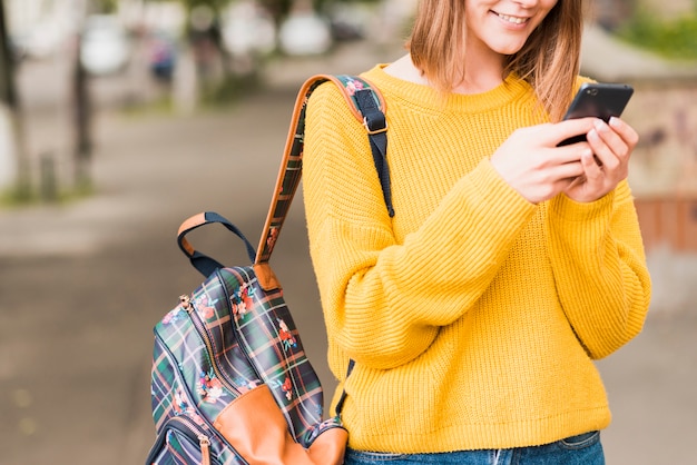 Smiley woman checking her phone