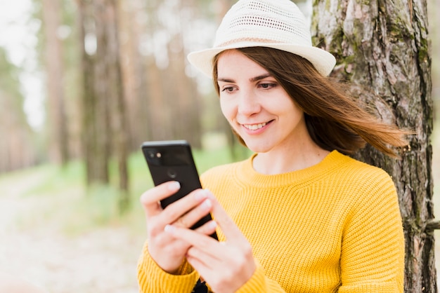 Smiley woman checking her phone