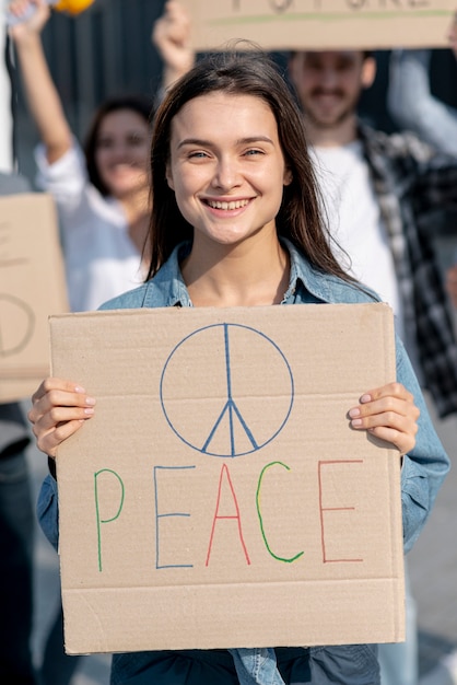 Free photo smiley woman demonstrating with activists