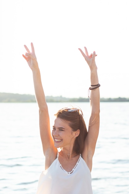 Smiley woman doing the peace sign