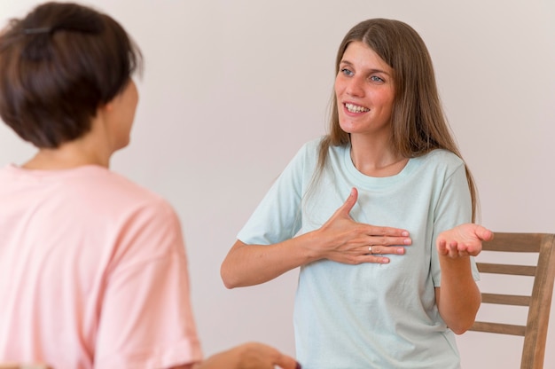 Smiley woman having a chat with someone using the sign language