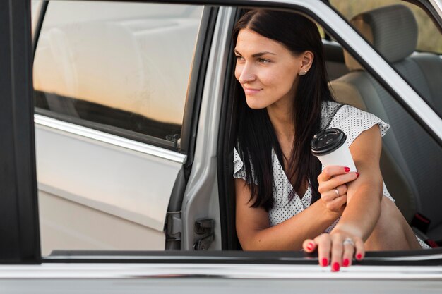 Smiley woman holding coffee cup