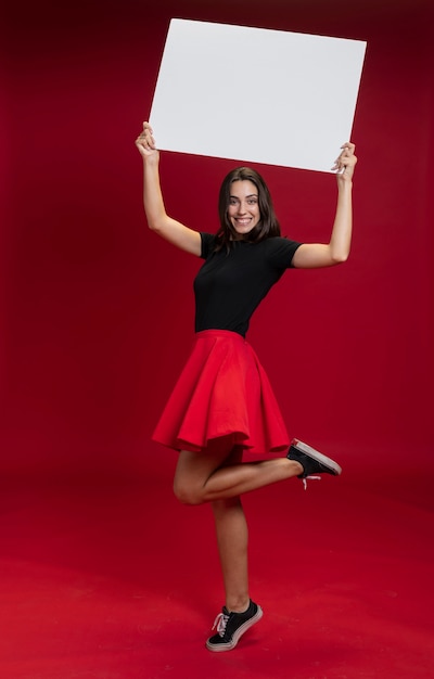 Smiley woman holding an empty banner