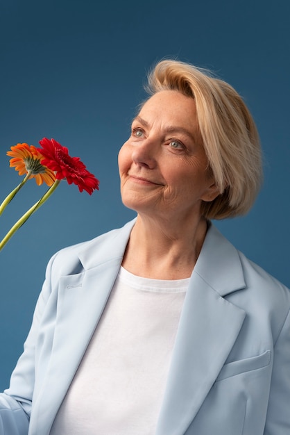 Smiley woman holding flowers medium shot